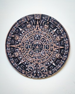 a black and gold plate with a design on it