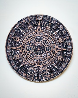 a black and gold plate with a design on it