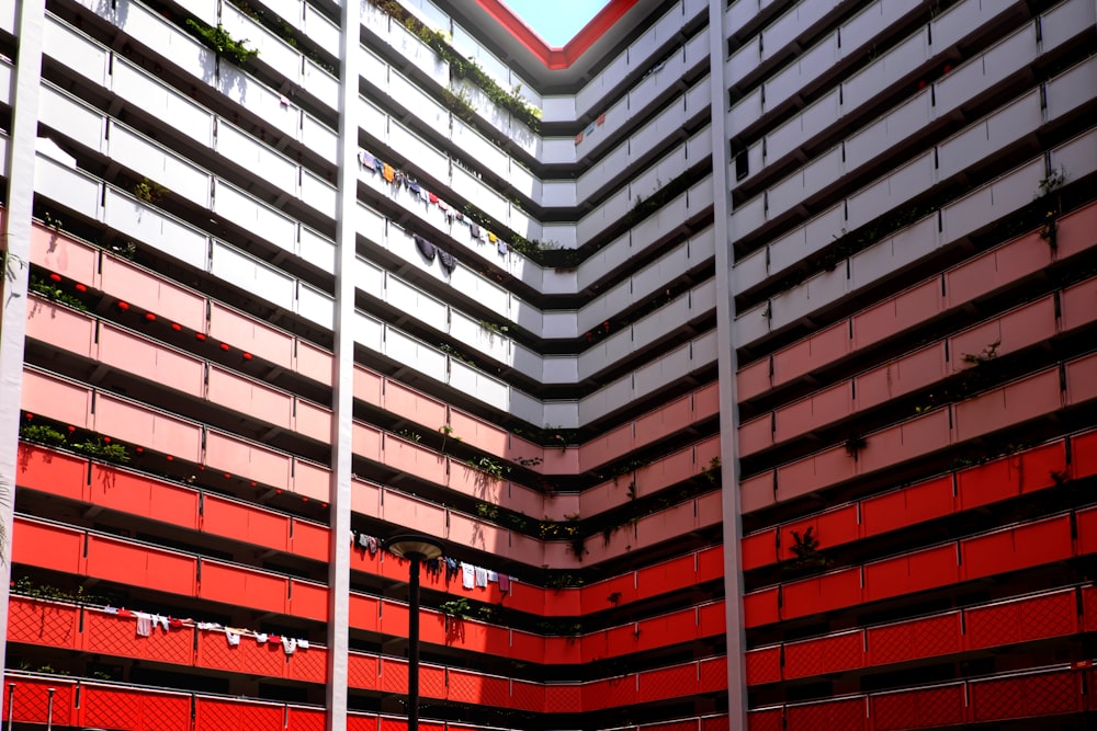 a tall building with a red and white facade