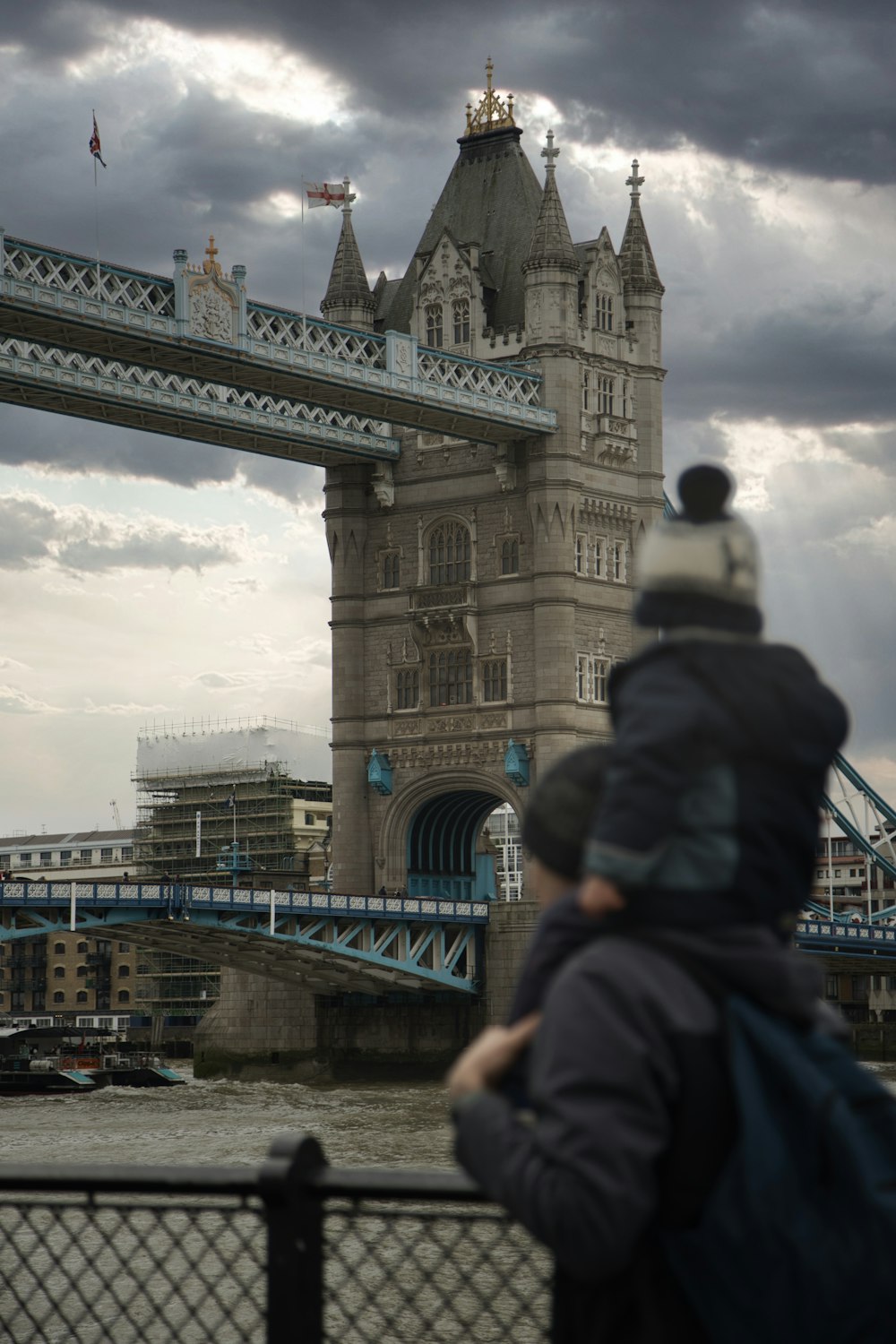 a person standing in front of a bridge