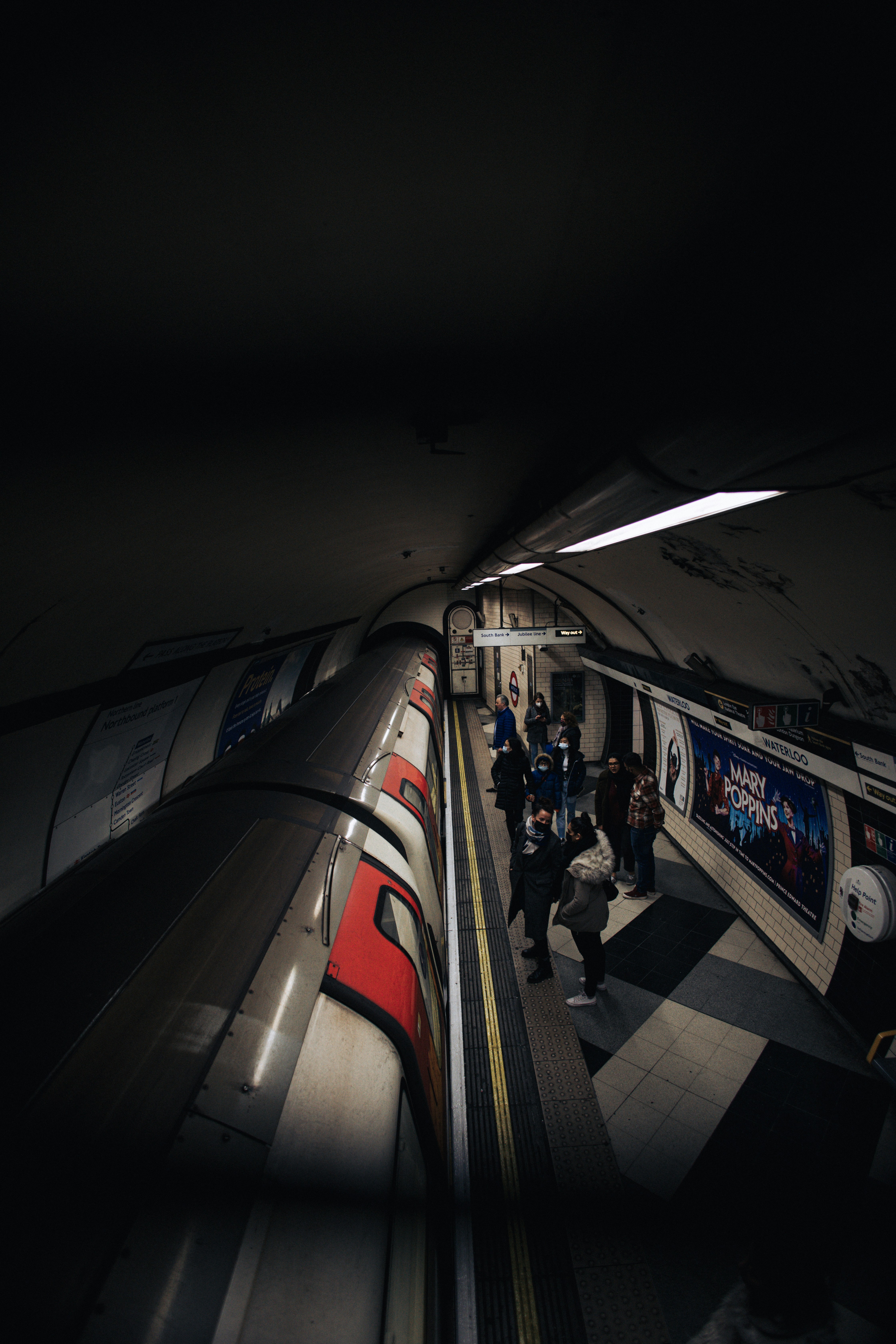 a group of people standing on a subway platform