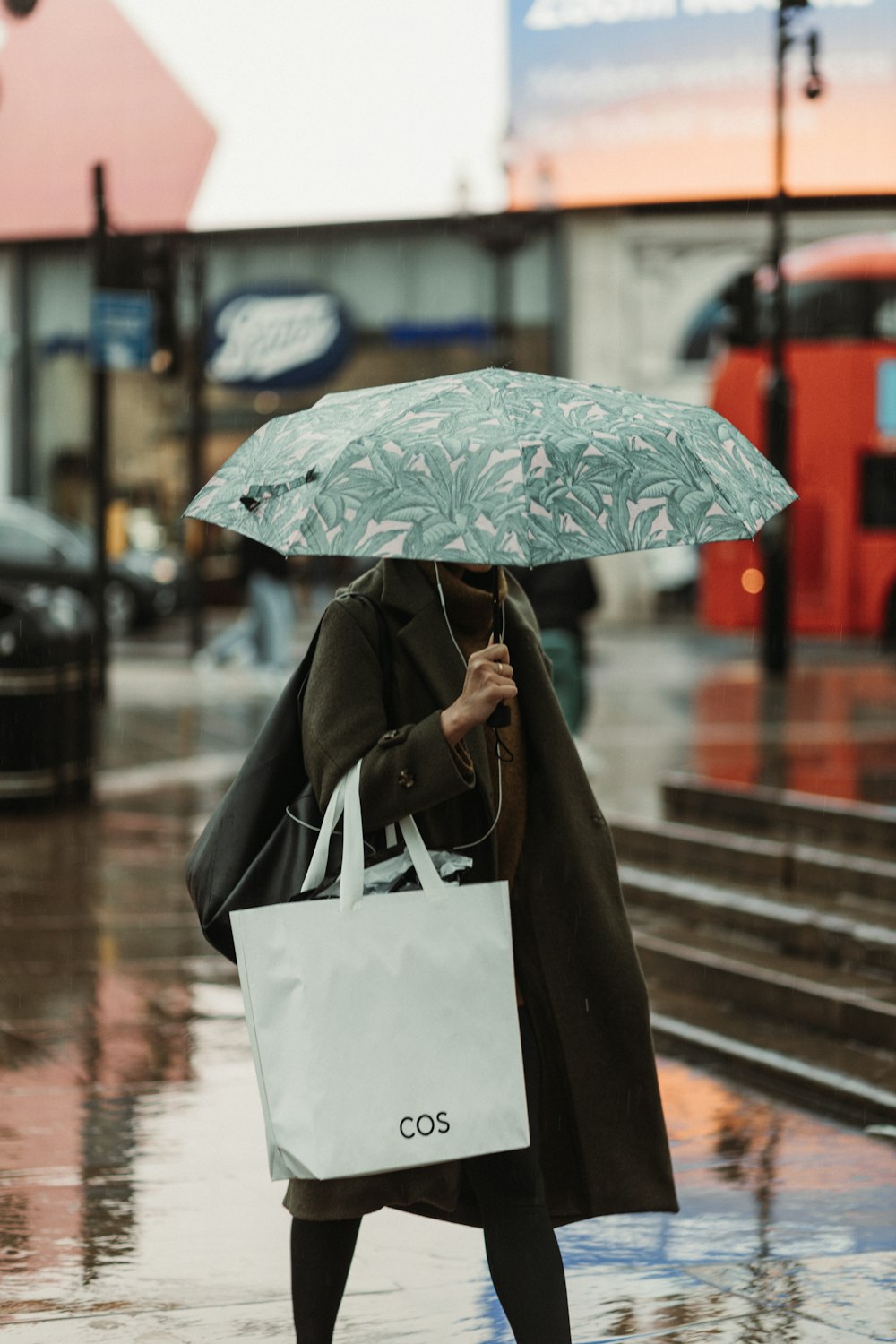 a woman walking down a street holding an umbrella