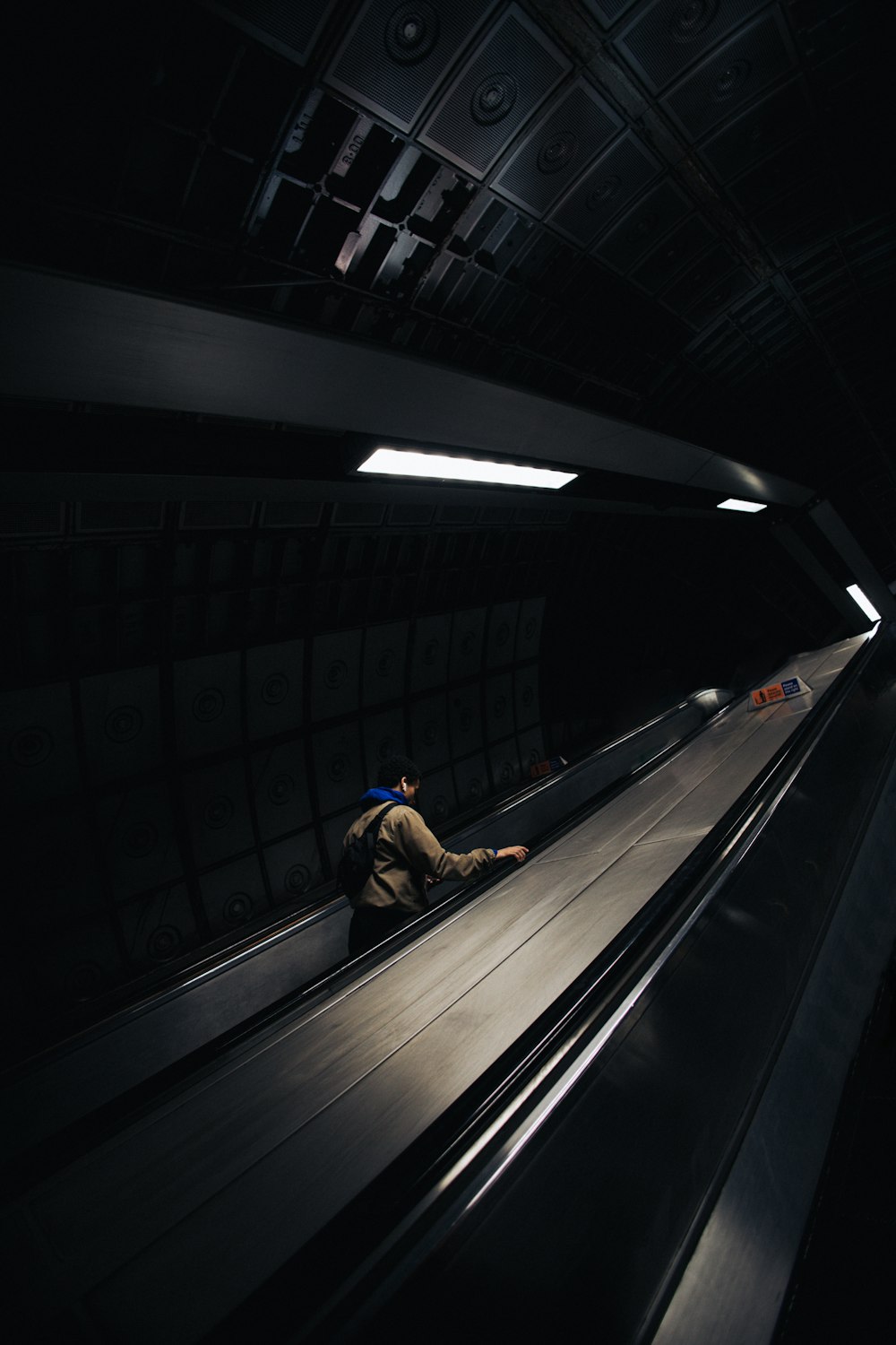 a man is laying down on an escalator