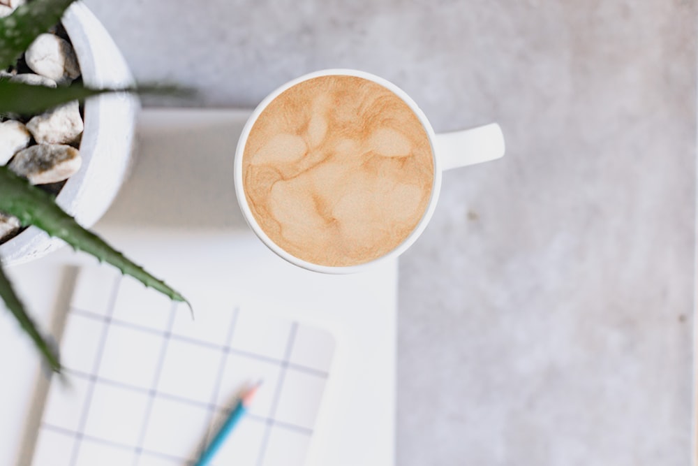 a cup of coffee sitting on top of a table