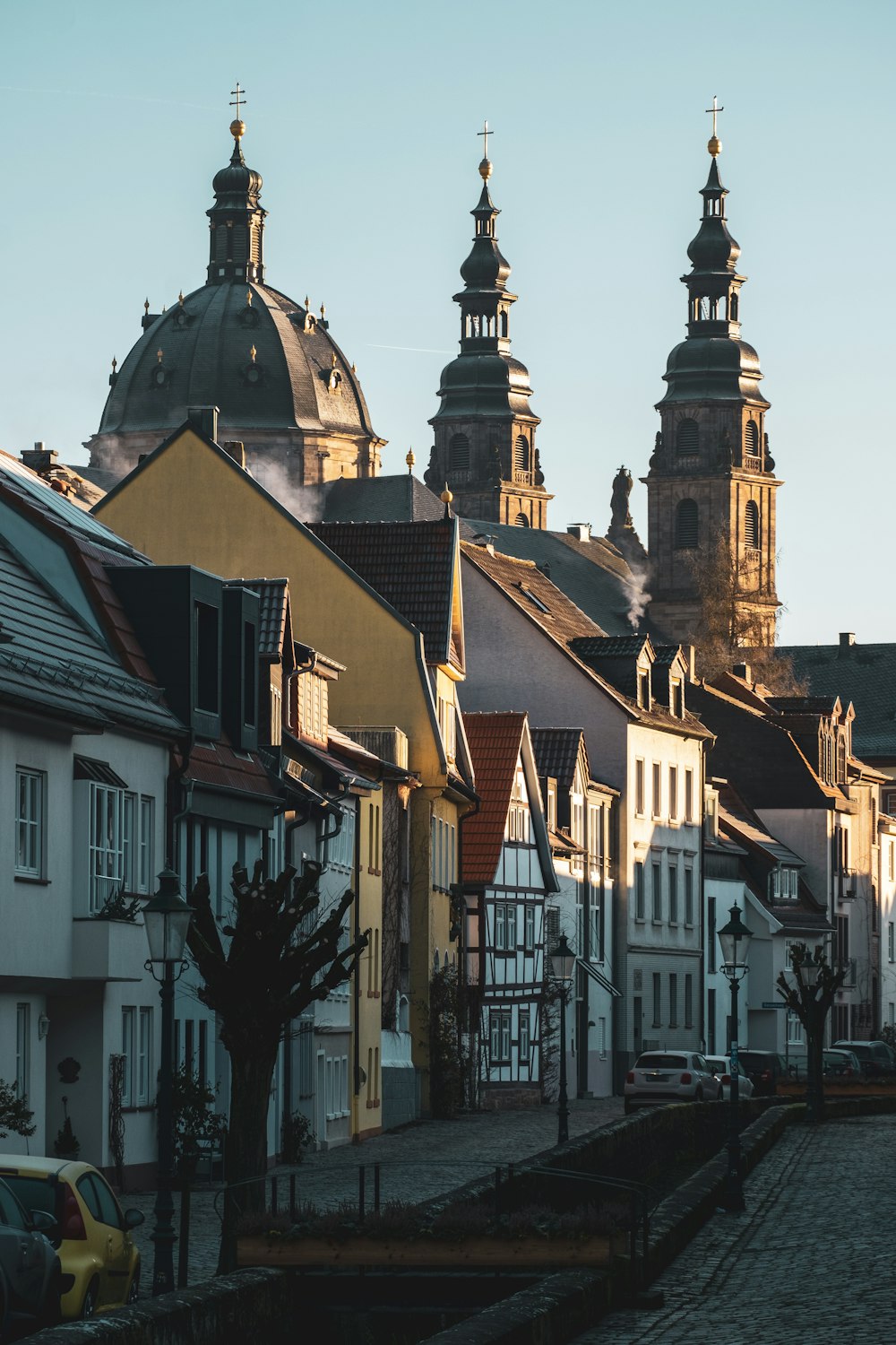 a row of buildings with a clock tower in the background