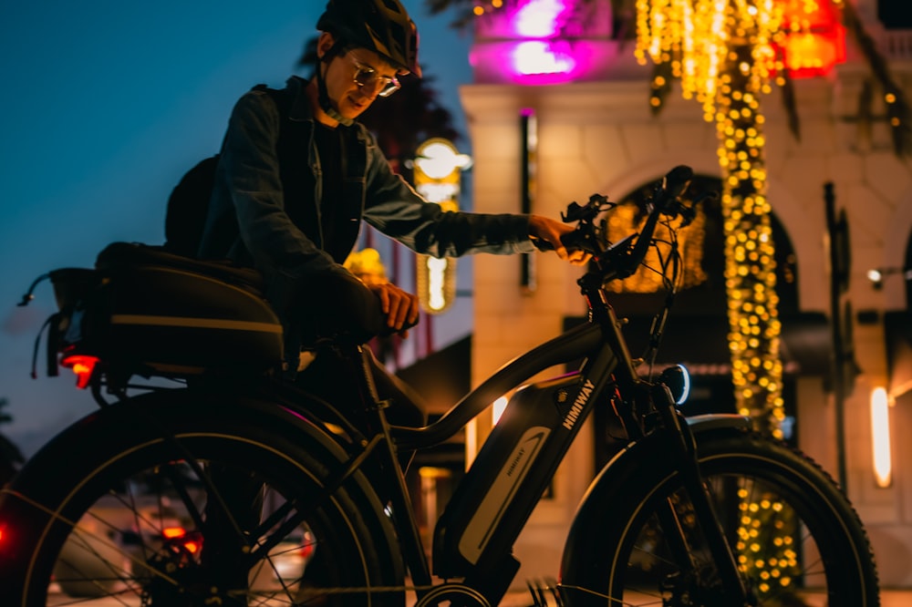 a person riding a bike on a city street