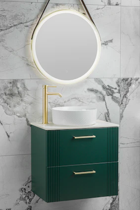 A sleek, modern bathroom featuring a brushed gold-accented vanity and smart mirror, bathed in natural light.