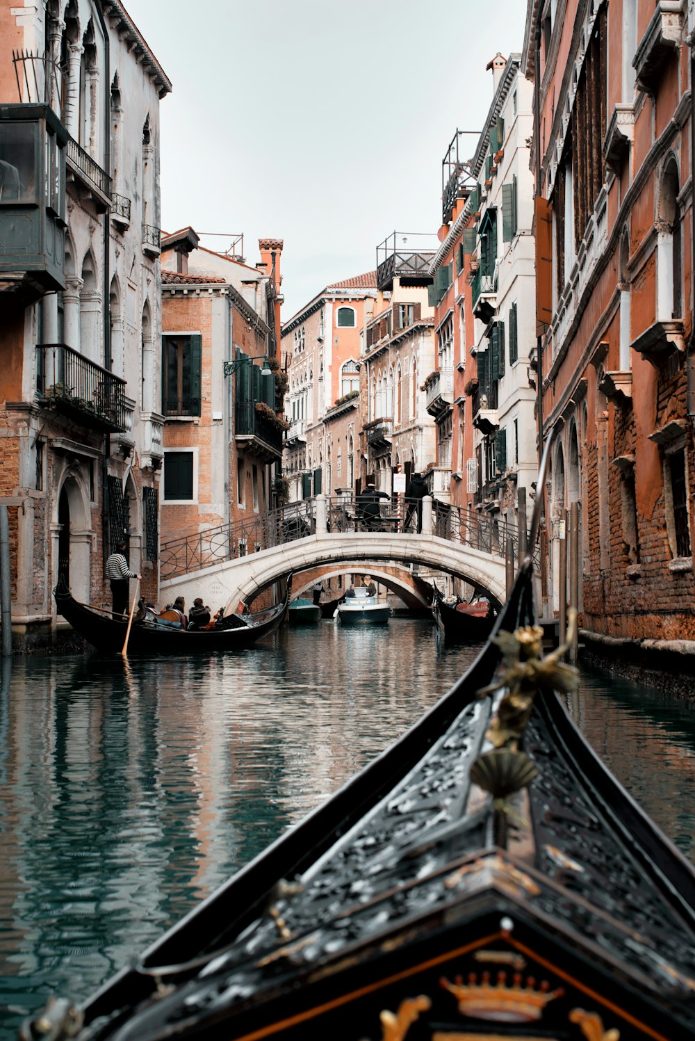 a boat traveling down a river next to tall buildings