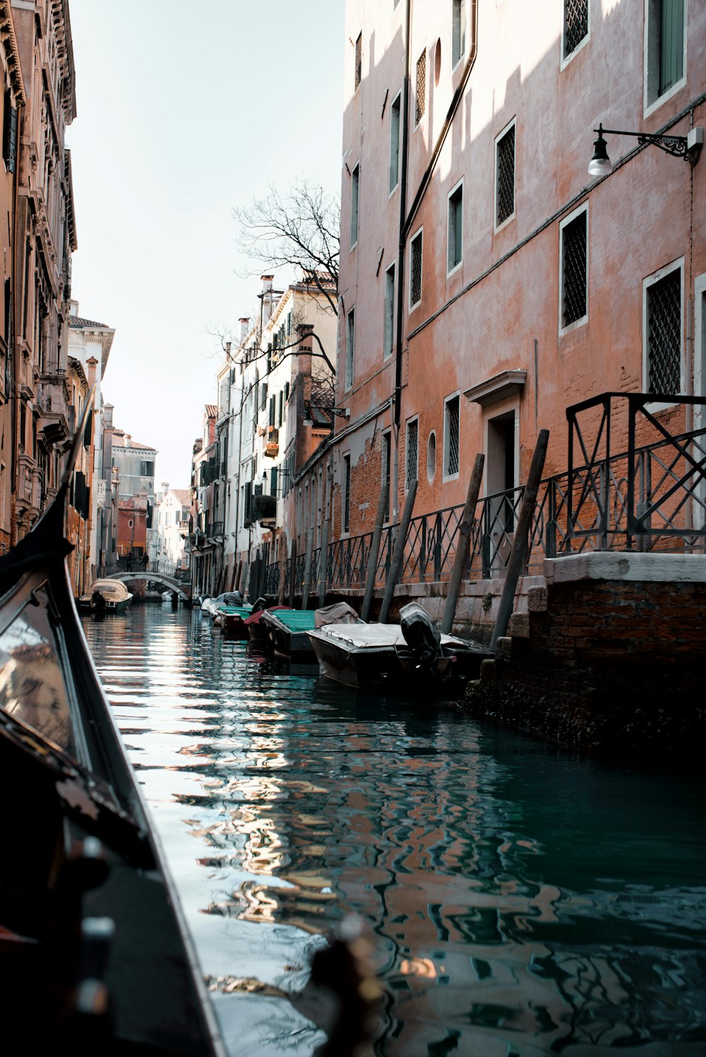 a boat is traveling down a narrow canal