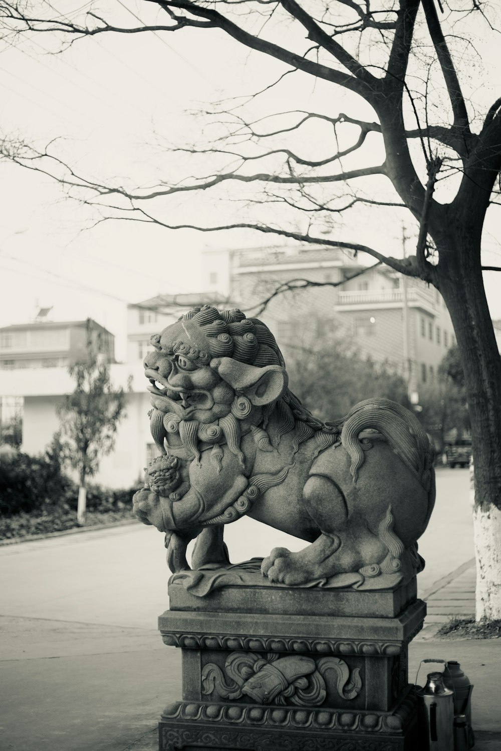 a statue of a lion on a sidewalk