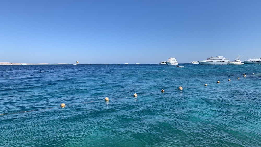 a line of boats floating in the ocean