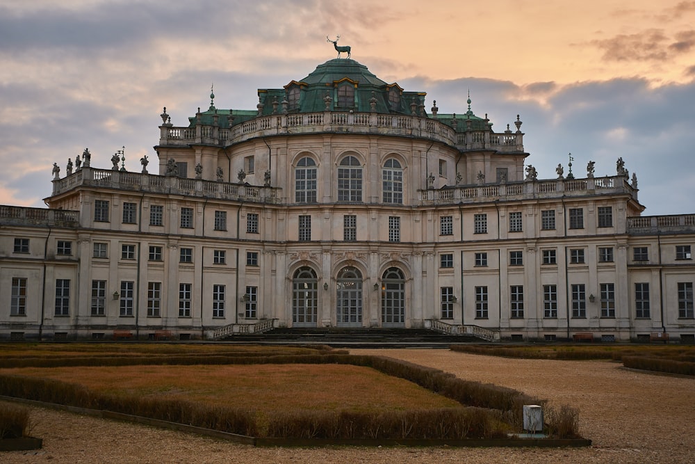 a large white building with a green roof