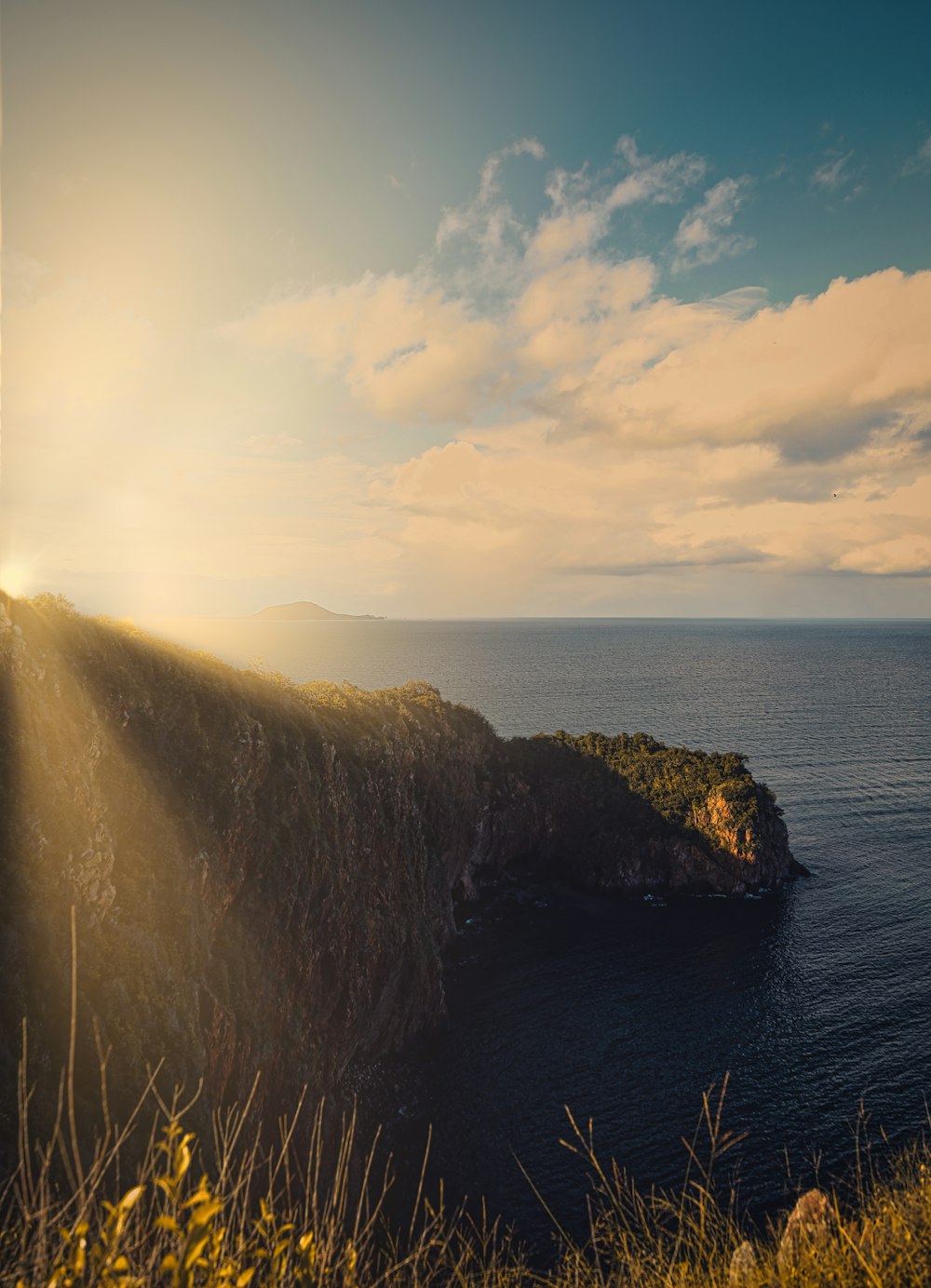 the sun shines through the clouds over the ocean