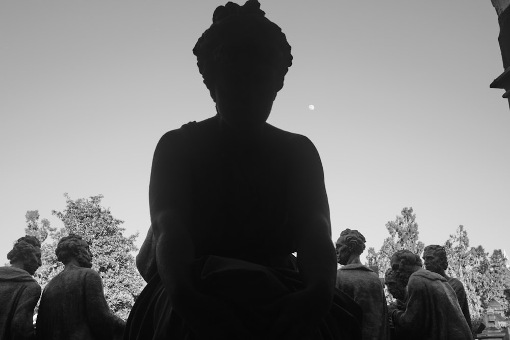 a black and white photo of a statue of a woman