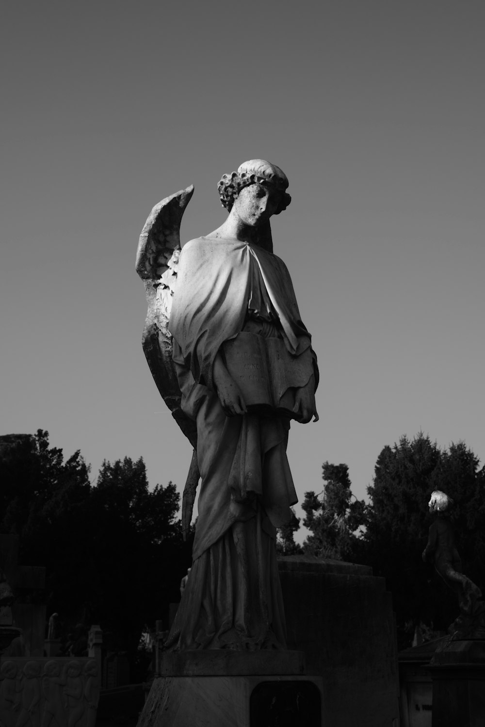 a black and white photo of a statue