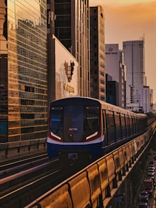 a train traveling through a city next to tall buildings