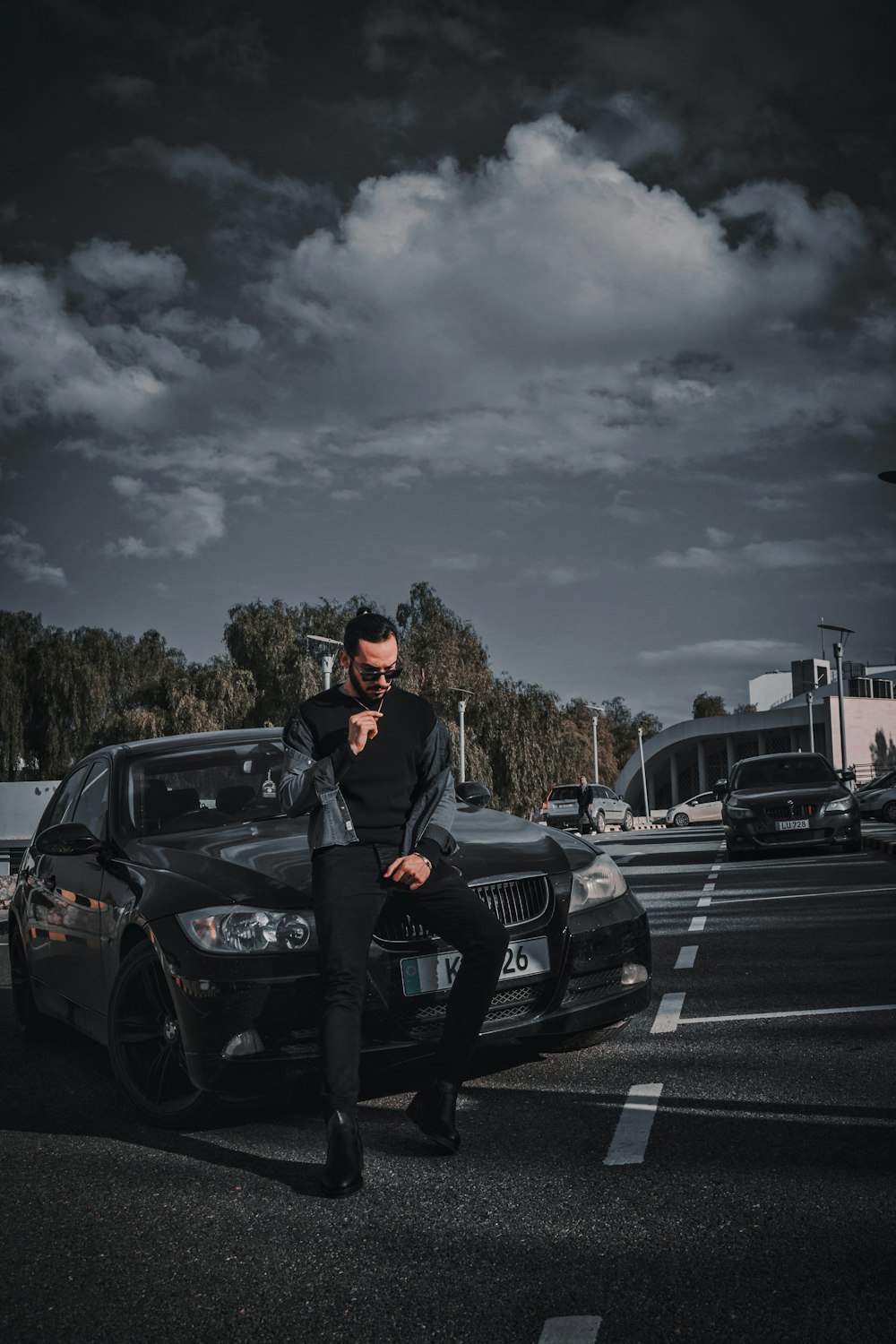 a man sitting on the hood of a car