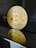a golden bit coin sitting on top of a table