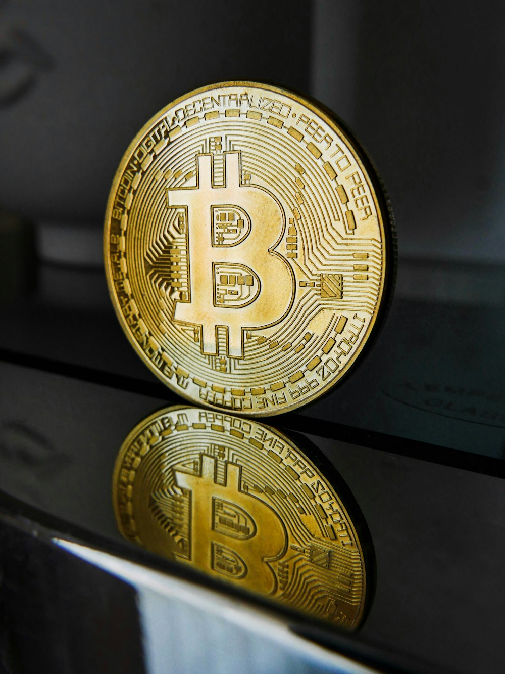 a golden bit coin sitting on top of a table