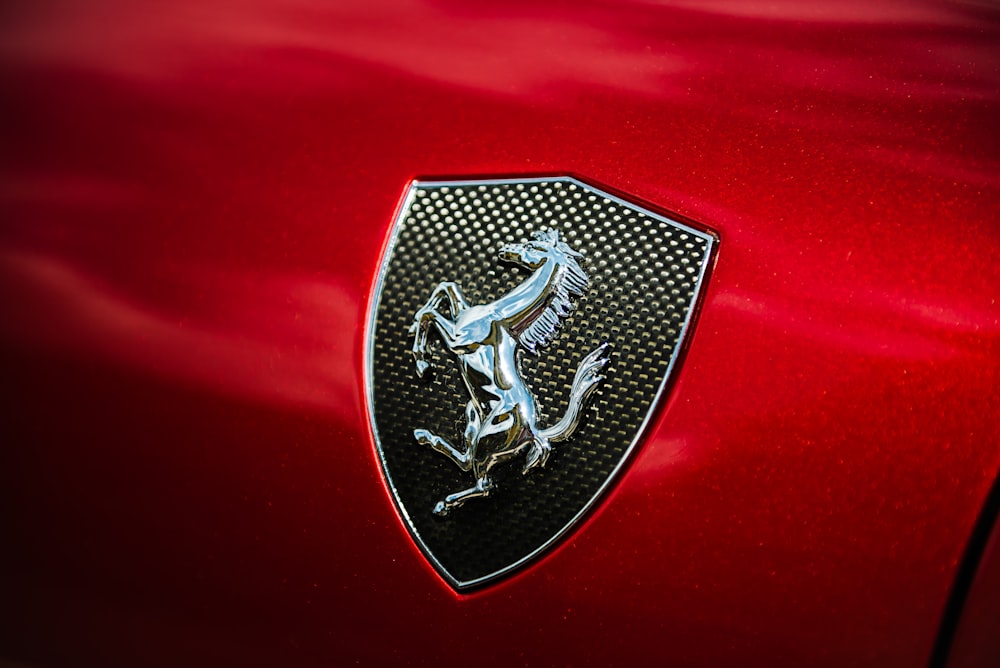 the emblem on the front of a red car