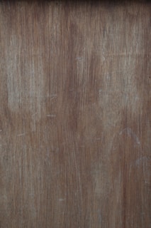 a close up of a wooden surface with scratches