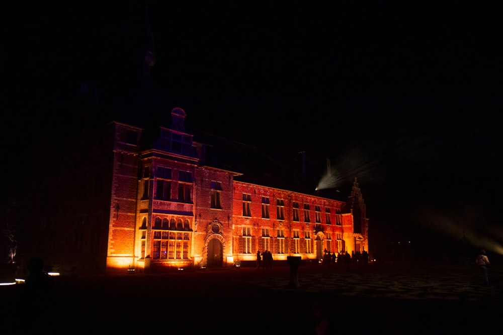 a large building lit up at night with lights