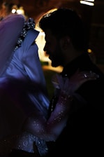 a man and a woman dressed in wedding attire
