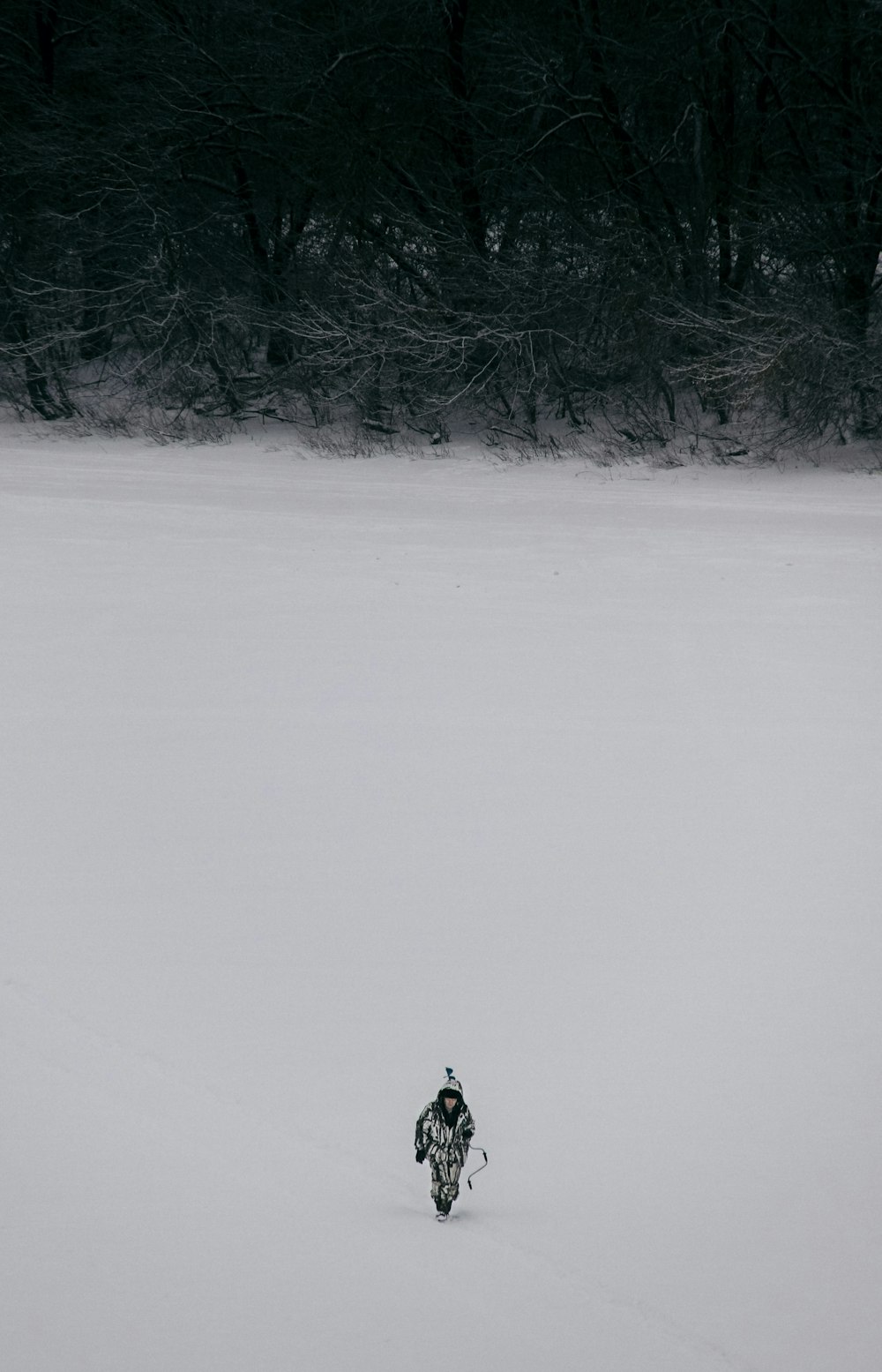 a person riding a motorcycle through a snow covered field