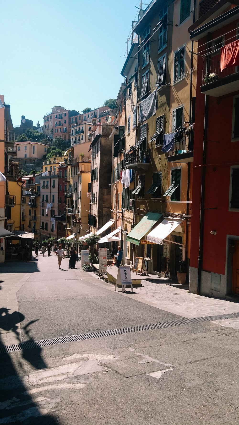 a city street with people walking down it