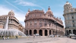a large building with a fountain in front of it