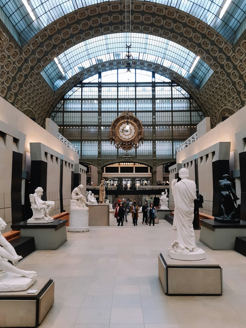 a group of statues sitting inside of a building