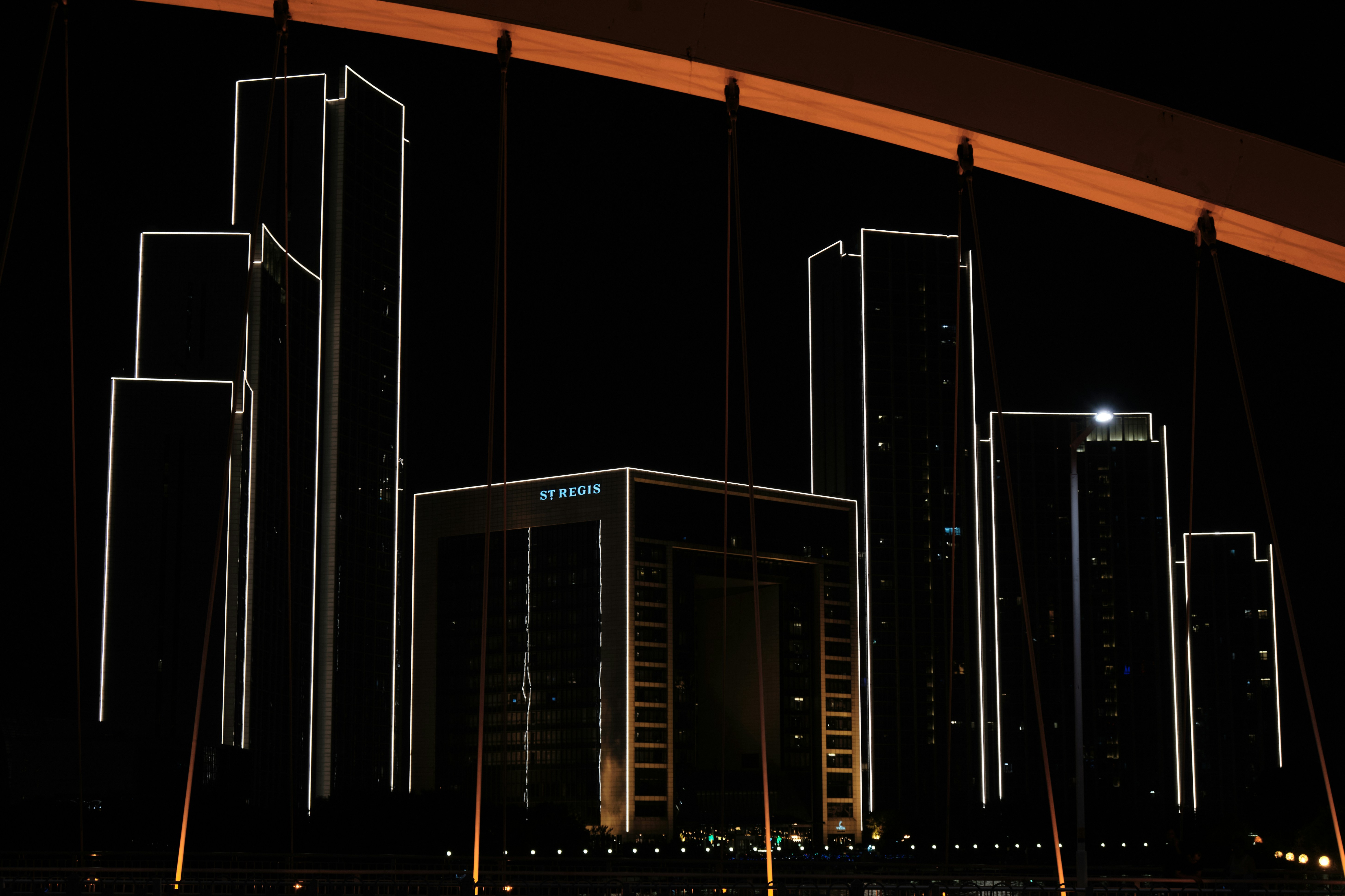 a picture of a city at night with buildings in the background