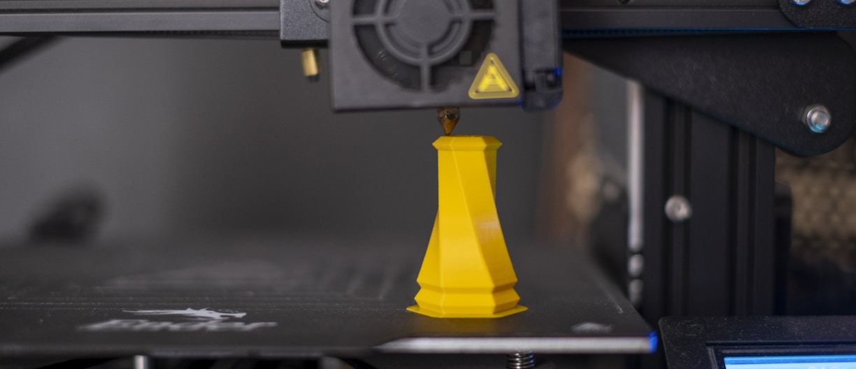 a 3d printer with a yellow cone on top of it