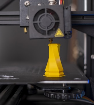 a 3d printer with a yellow cone on top of it
