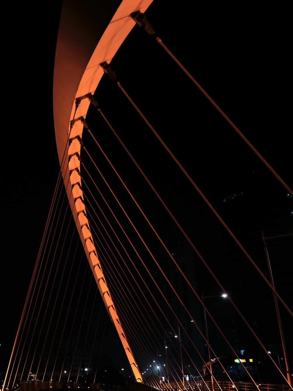 a view of a very tall bridge at night