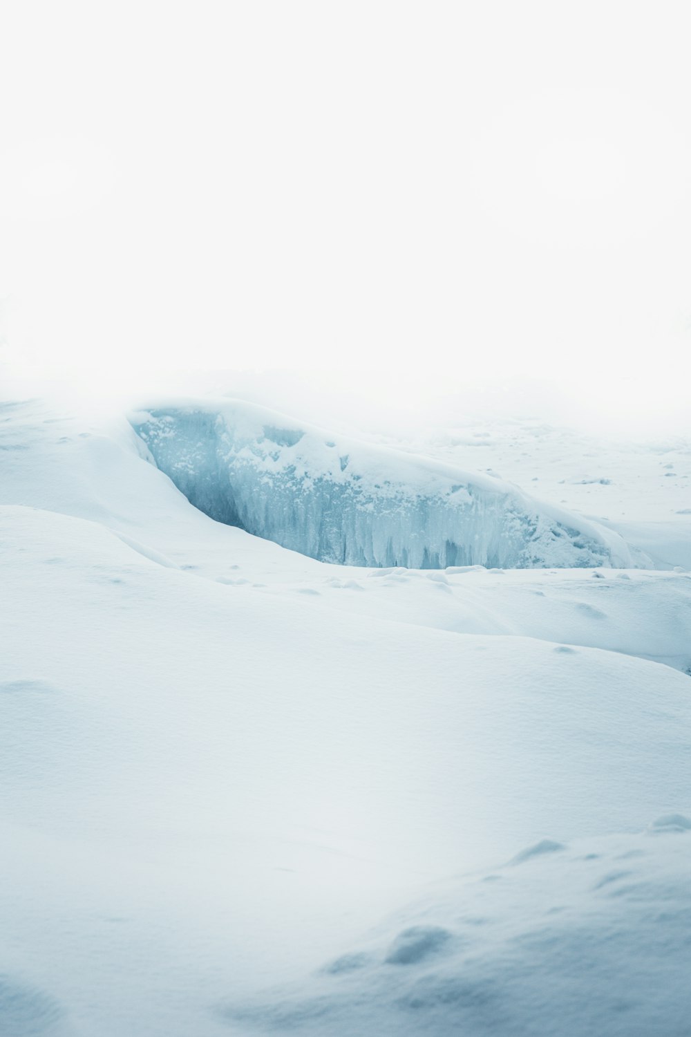 a man riding skis down a snow covered slope