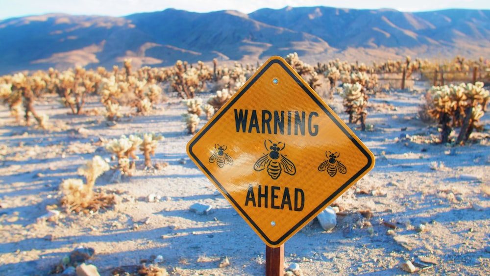 a warning sign in the middle of a desert