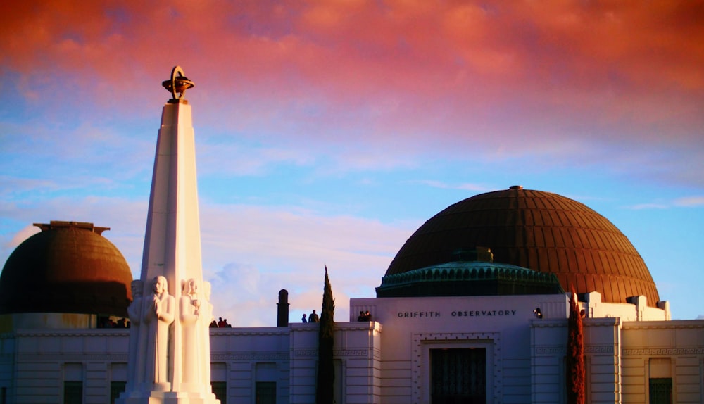 a large white building with two domes on top of it