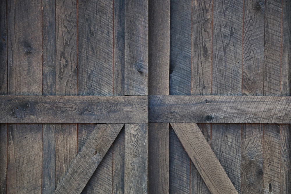 a close up of a wooden door with a metal handle