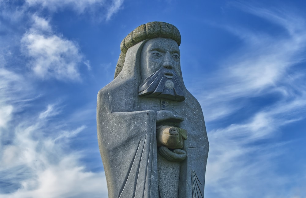 a statue of a man with a fish in his hand