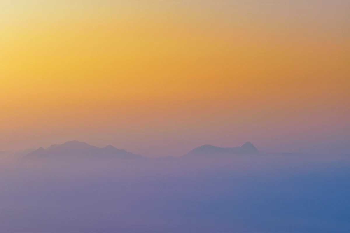 Hazy blue ridgelines of the Velliangiri Hills at sunrise