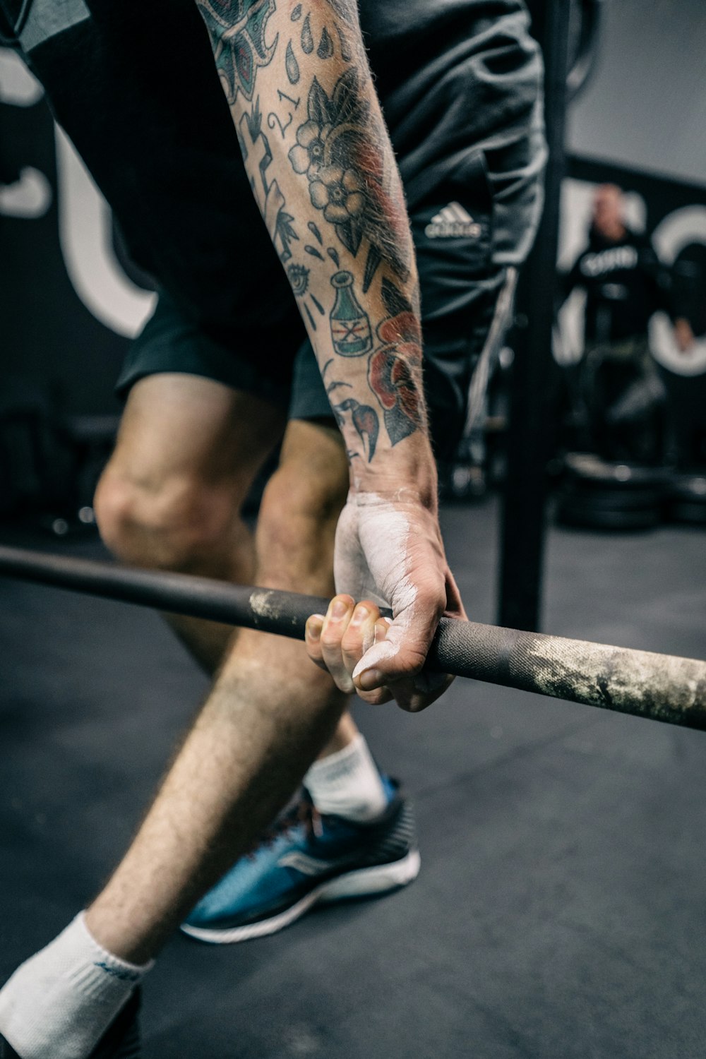 a man holding a bar in a gym