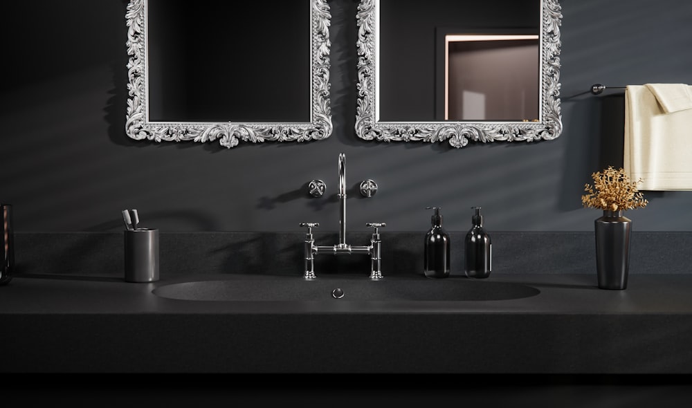 a bathroom sink with two mirrors above it