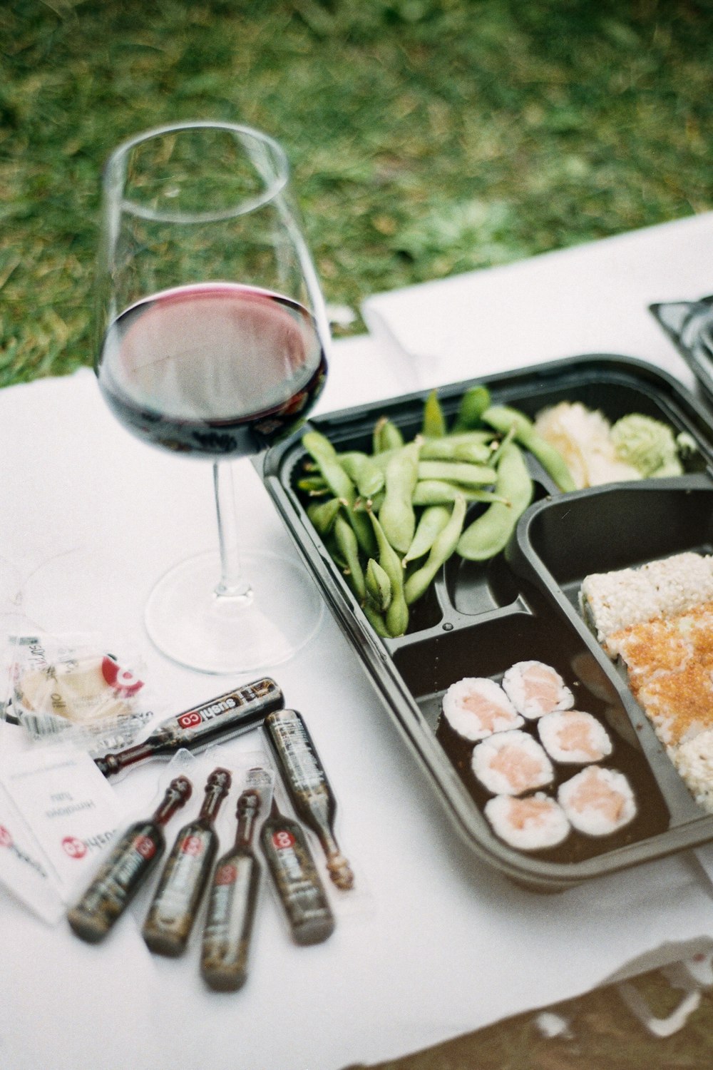 a glass of wine and some food on a table