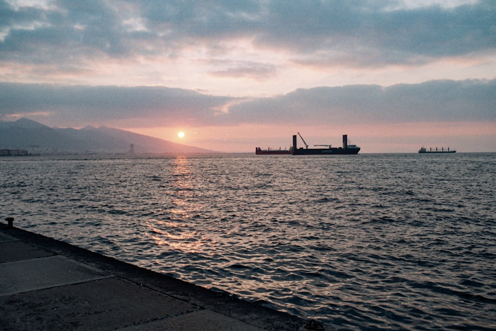 the sun is setting over a large body of water