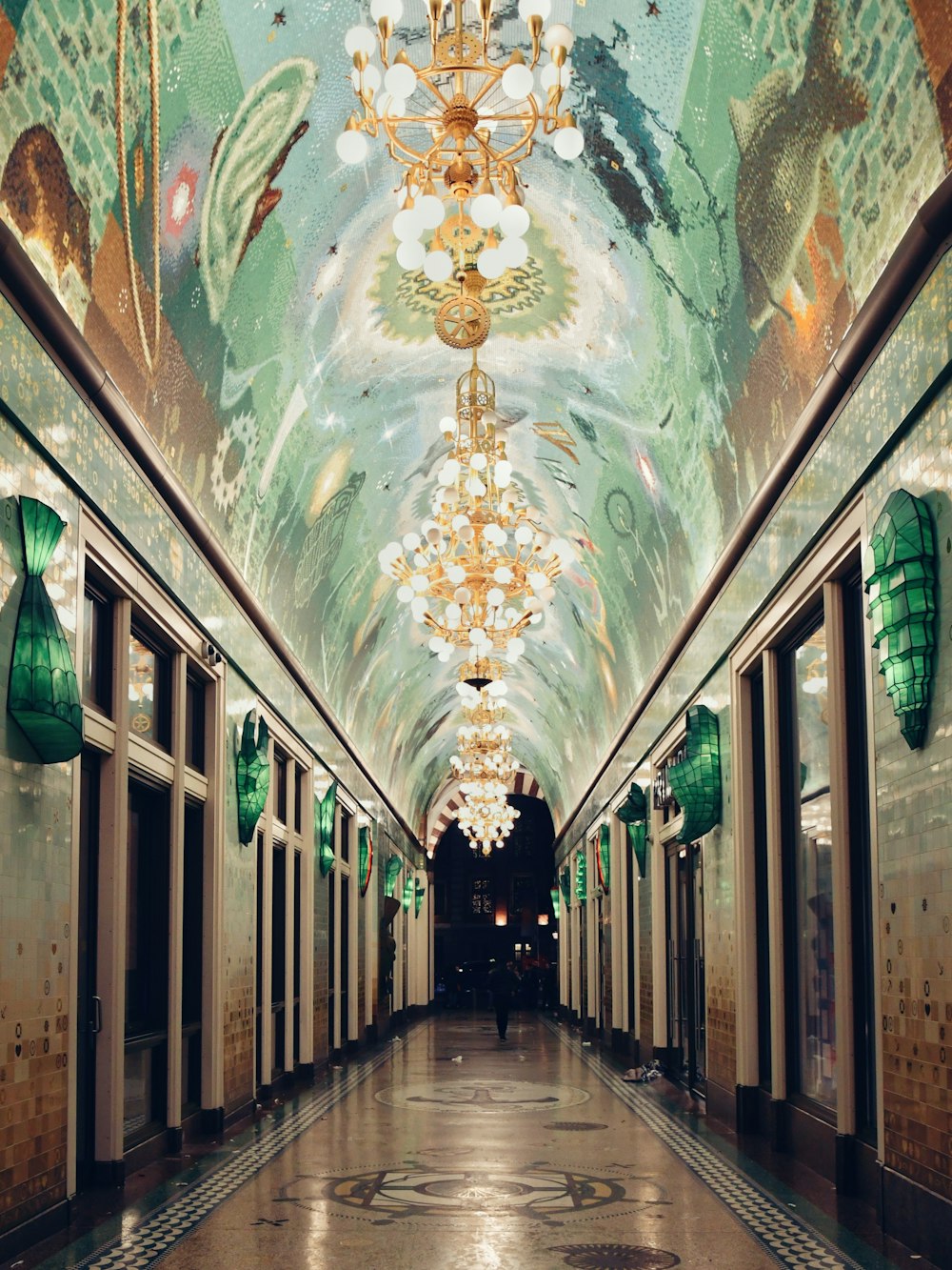 a long hallway with a chandelier hanging from the ceiling