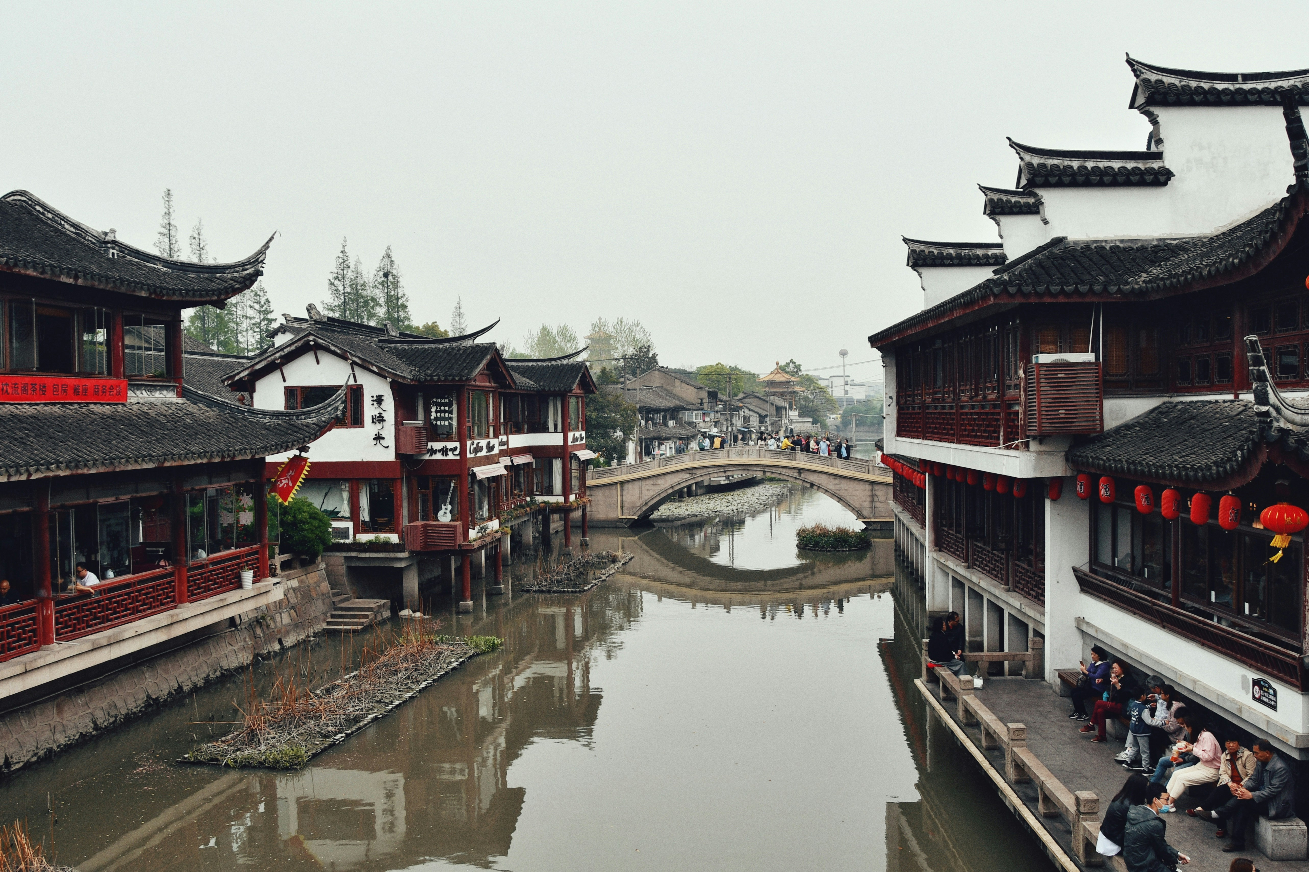 a river running through a city next to tall buildings