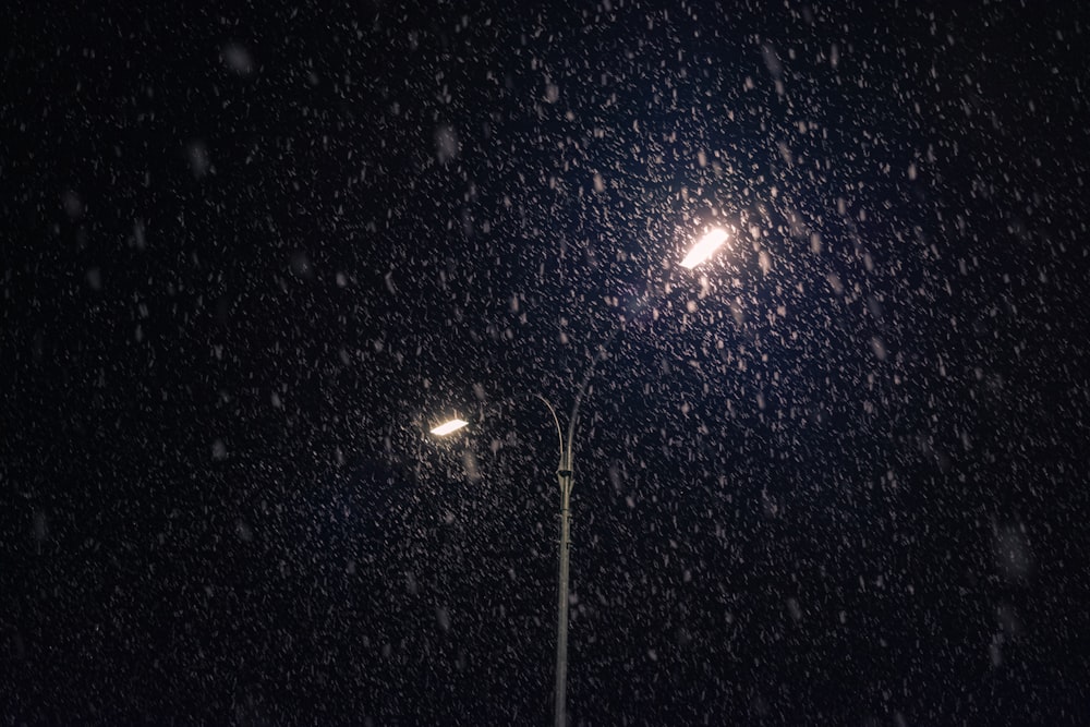 a street light in the snow at night