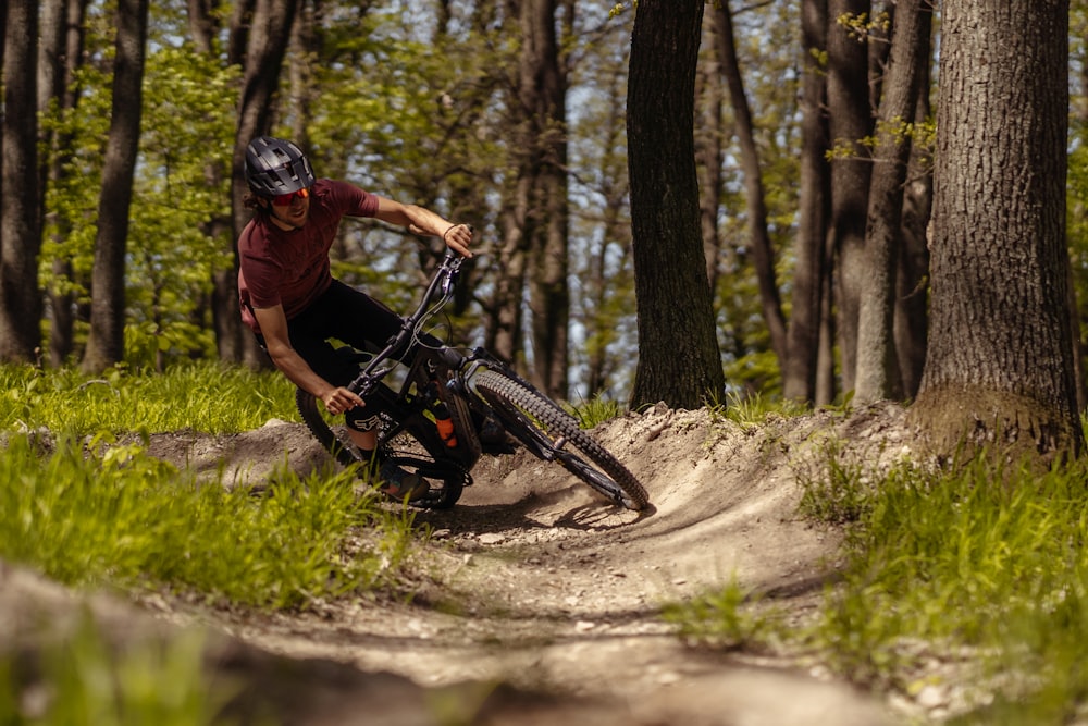 a man riding a mountain bike through a forest