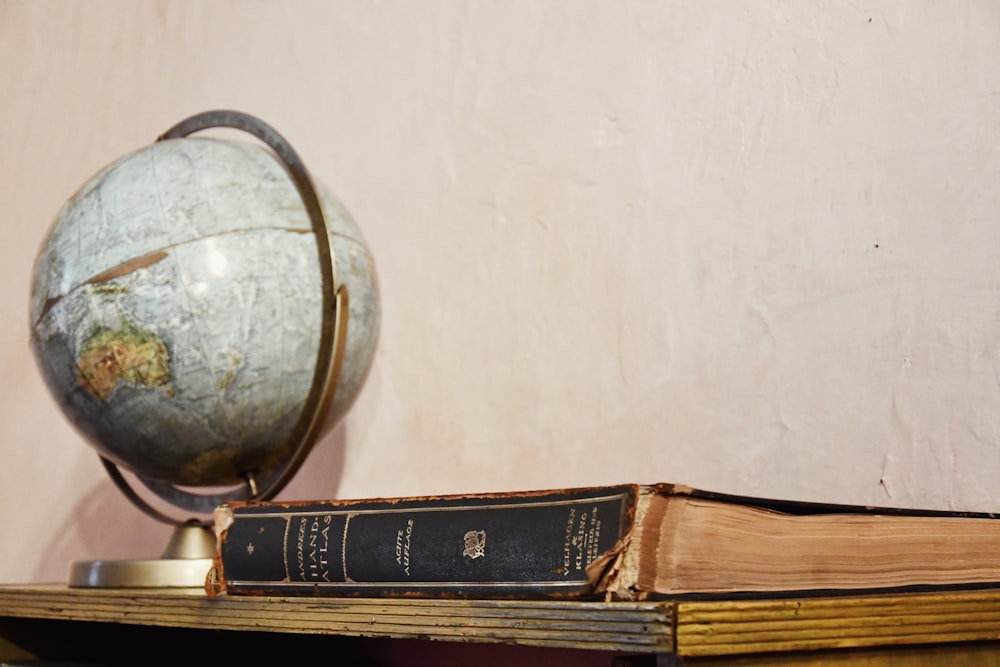 a globe sitting on top of a wooden table